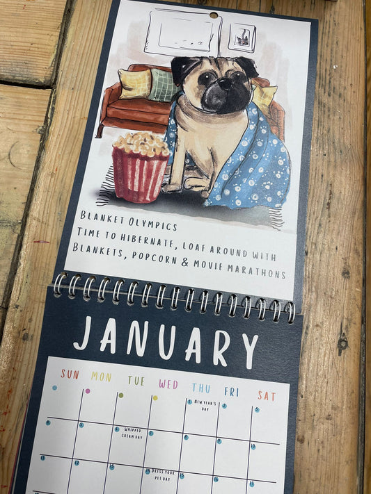 Calendar with a pug illustration on a wooden surface