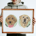 Person holding a framed portrait of two dogs named Daisy and Hector.